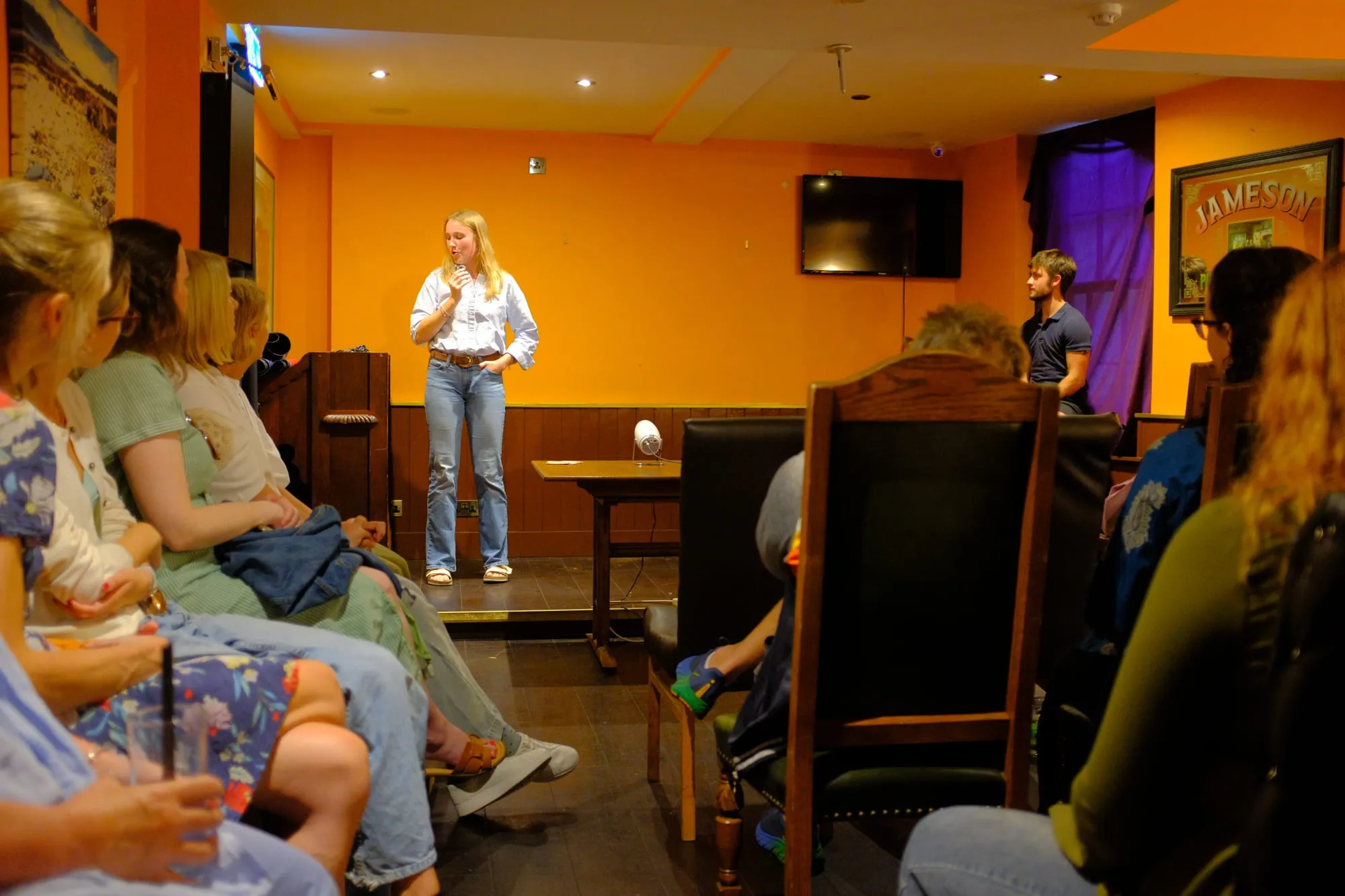 Rosalie van Zutphen speaking to an audience sitting along the wall